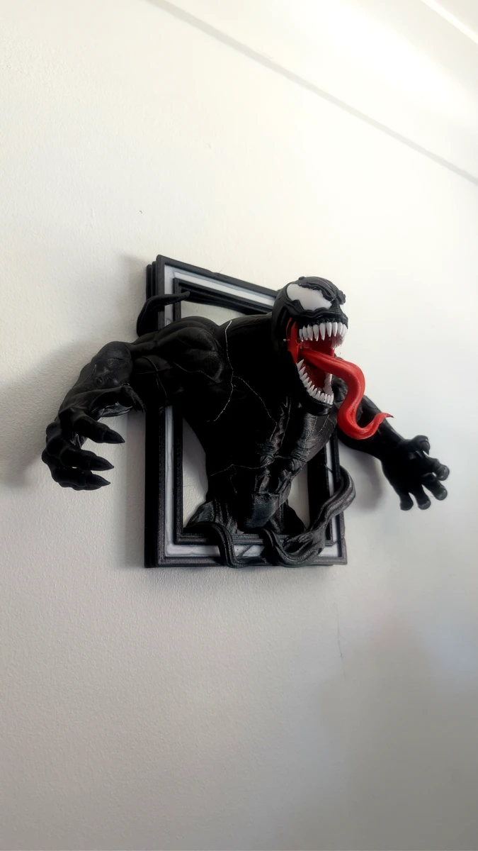 3D printed Venom character bursting out of a wall mounted picture frame