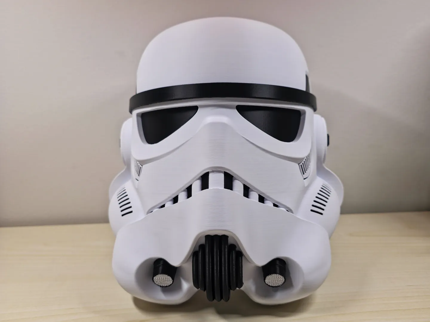 White and black 3D-printed stormtrooper helmet shown from the front